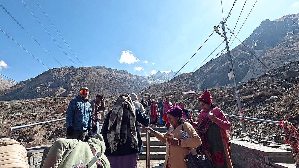 Pilgrims stone stairway temple approach snow peaks Muktinath Mustang Nepal Hindu pilgrimage