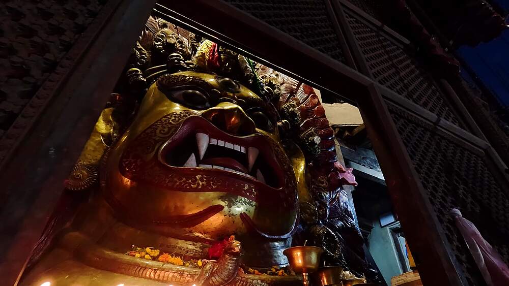 Slide across the snarling gilded mask of Seto Bhairab behind its lattice screen, Kathmandu, Nepal