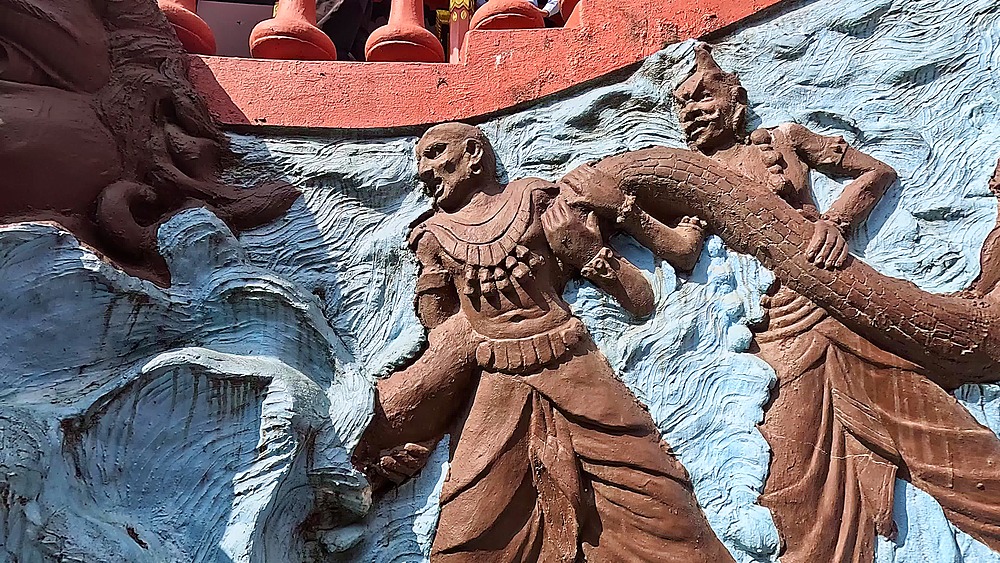 Slide along the Samudra Manthan relief of gods churning the ocean at Gupteshwor Mahadev Cave, Pokhara, Nepal