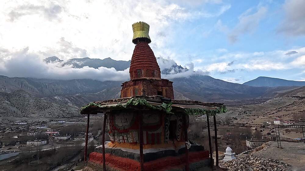Tall chorten spire panoramic valley overview Ghiling Upper Mustang mountains landscape
