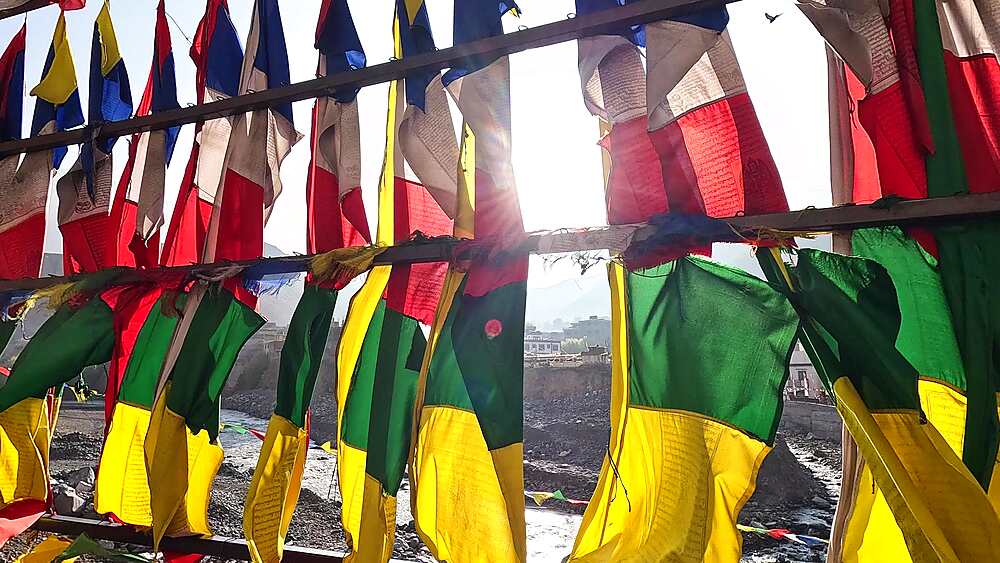 Close-up wind-blown prayer flags, vibrant colors, Buddhist prayers, Kali Gandaki Nepal