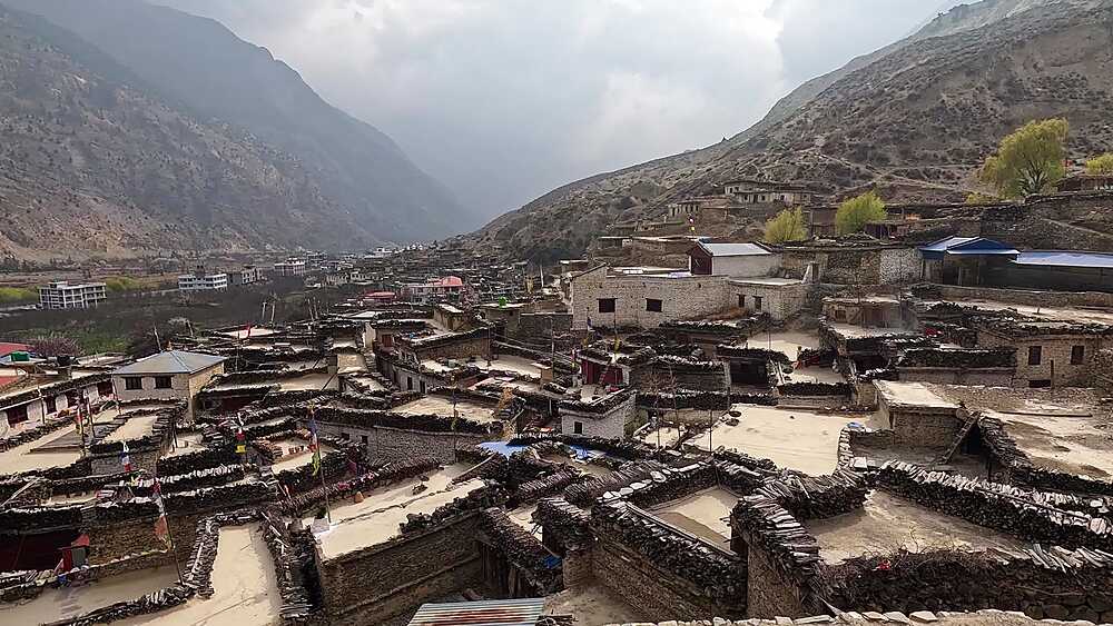 Elevated view Marpha settlement, stone buildings, dry valley, mountains Mustang