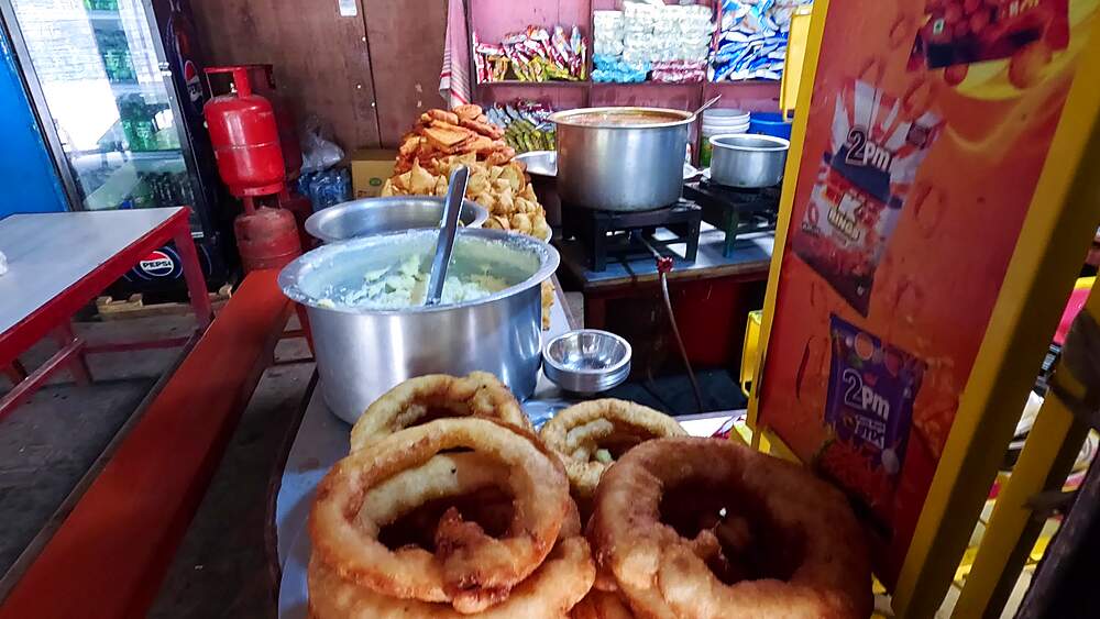 Homemade jalebi coils, traditional Nepali fried dessert sweets, street food stall display Pokhara