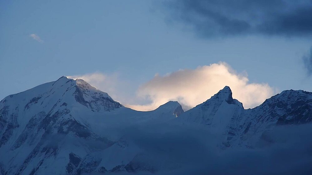 Sunset time lapse of cloud drifting over the snow-capped peaks of the Annapurna massif, Nepal