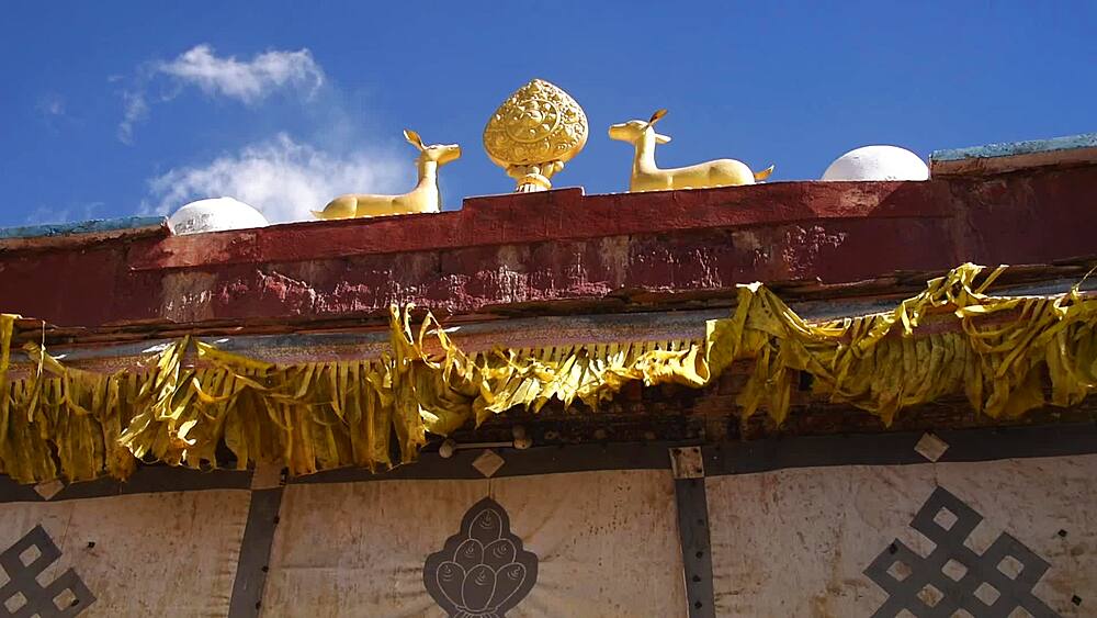Gilded dharmachakra wheel and twin deer roof ornament on a monastery, Lo Manthang, Upper Mustang, Nepal