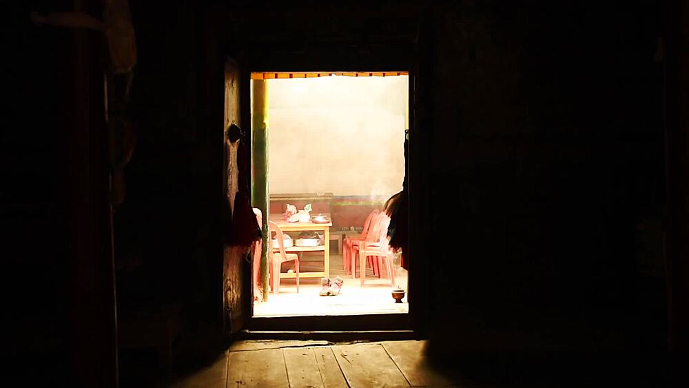 Incense smoke drifting through the doorway of the Luri Gompa cave monastery, Yara, Upper Mustang, Nepal