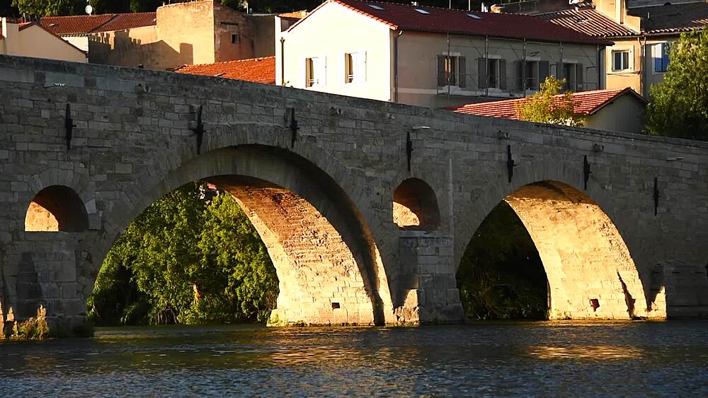 Golden light on the arches of the Pont Vieux crossing the Orb, Beziers, Herault, Occitanie, France