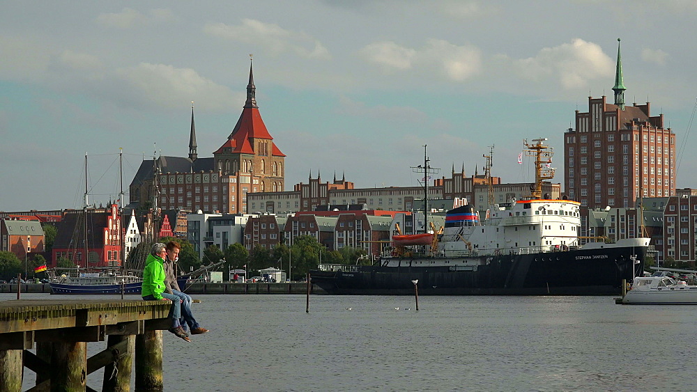 Warnowufer Street on Warnow River with St. Mary's Church, Rostock, Mecklenburg-Western Pomerania, Germany