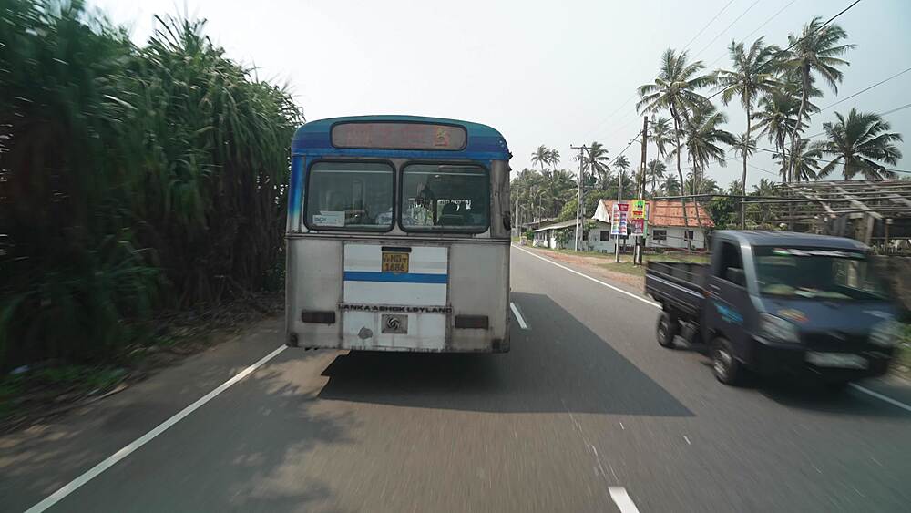 Elevated view tuk tuks and other traffic in road near Galle, Southern Province, Sri Lanka, Asia
