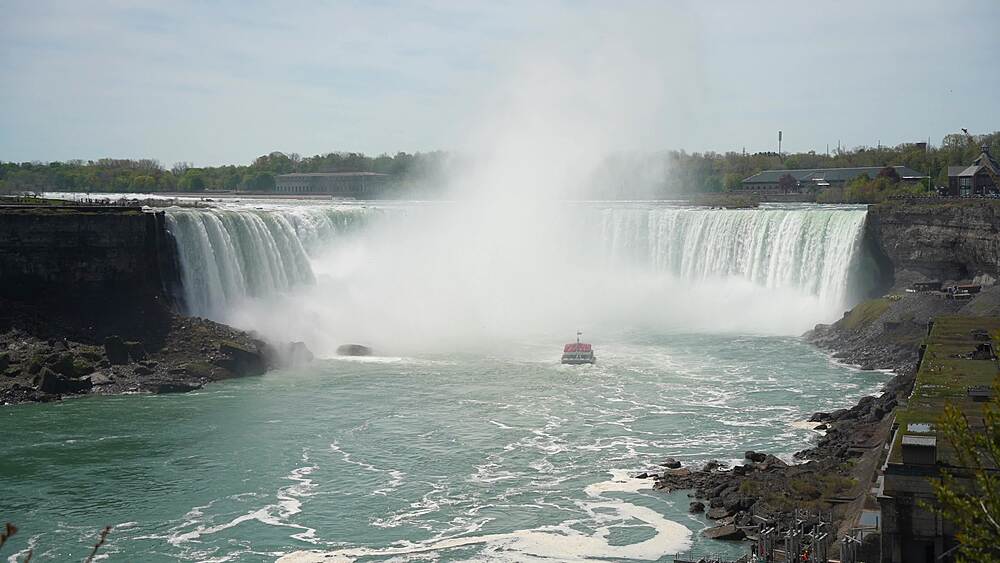 View of the Maid of the Mist tour boat entering Horseshoe Falls from Canada on a sunny day, Niagara Falls, Ontario, Canada, North America