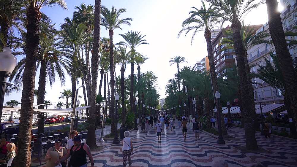 View of people on Explanada of Spain during golden hour on a sunny day, Alicante, Costa Blanca, Spain, Europe