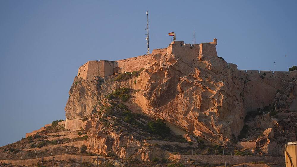 View of Castillo de Santa Barbara from Alicante old town during golden hour on a sunny day in Alicante, Alicante, Costa Blanca, Spain, Europe
