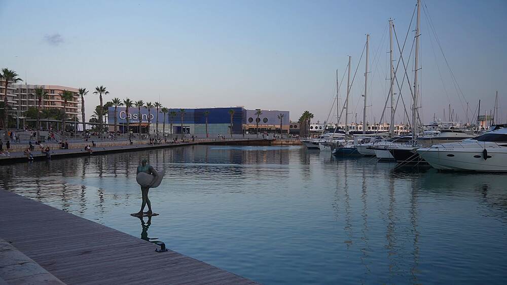 View of boats in Alicante Marina and Casino during golden hour on a sunny day, Alicante, Costa Blanca, Spain, Europe
