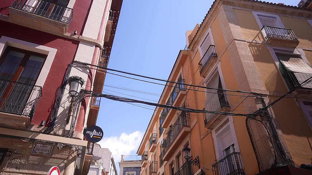 View of covered balconies on colourful buildings in old town on a sunny day, Alicante, Costa Blanca, Spain, Europe