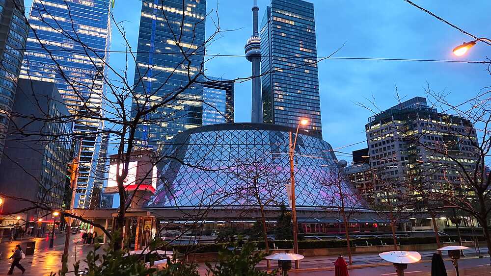 View of city trams, St. Andrew's Presbyterian Church, Roy Thomson Hall and CN Tower at dusk, Toronto, Ontario, Canada, North America