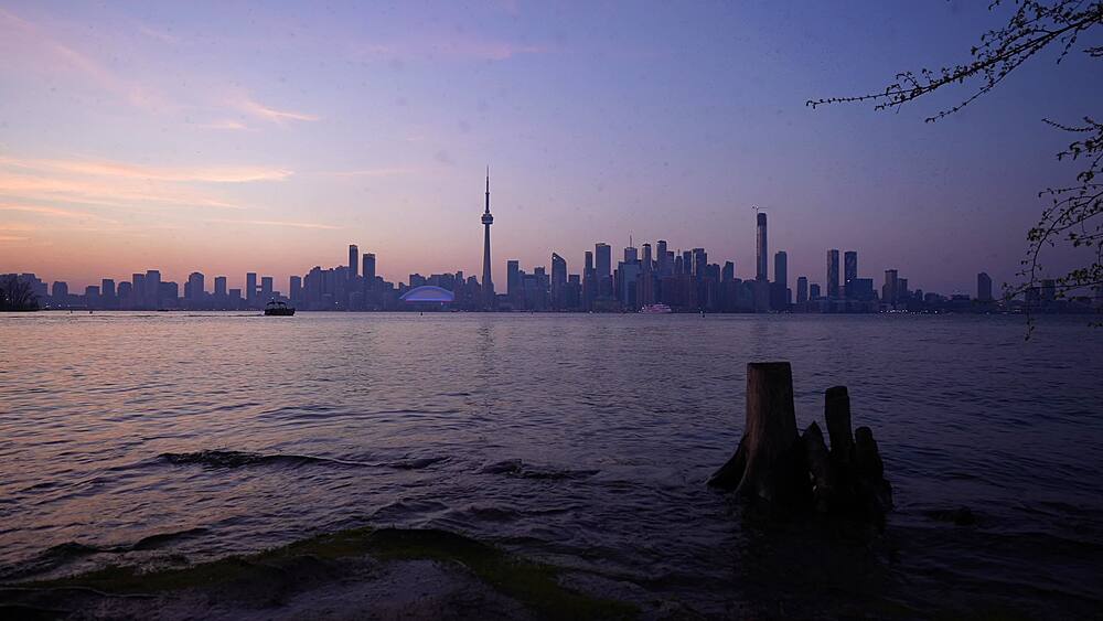 View of Toronto skyline and CN Tower from Middle Island at dusk, Toronto, Ontario, Canada, North America