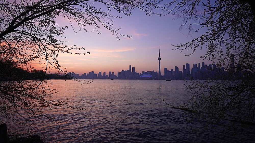 View of Toronto skyline and CN Tower from Middle Island at dusk, Toronto, Ontario, Canada, North America
