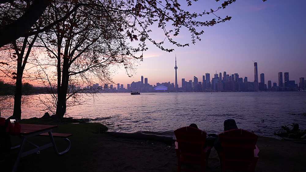 View of Toronto skyline and CN Tower from Middle Island at dusk, Toronto, Ontario, Canada, North America