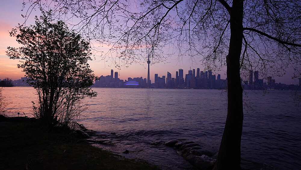 View of Toronto skyline and CN Tower from Middle Island at dusk, Toronto, Ontario, Canada, North America