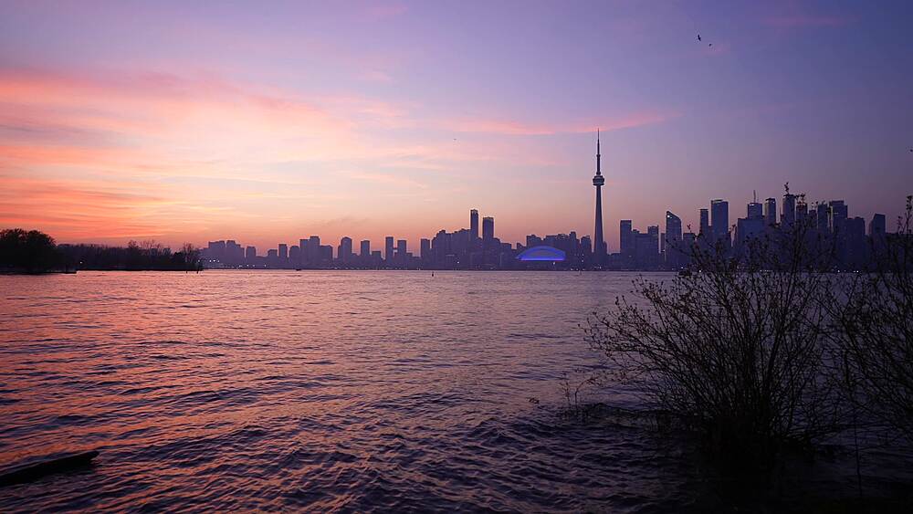View of Toronto skyline and CN Tower from Middle Island at dusk, Toronto, Ontario, Canada, North America