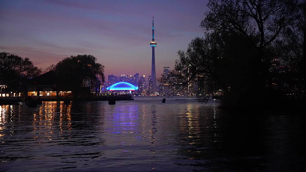 View of Toronto skyline and CN Tower from Middle Island at dusk, Toronto, Ontario, Canada, North America