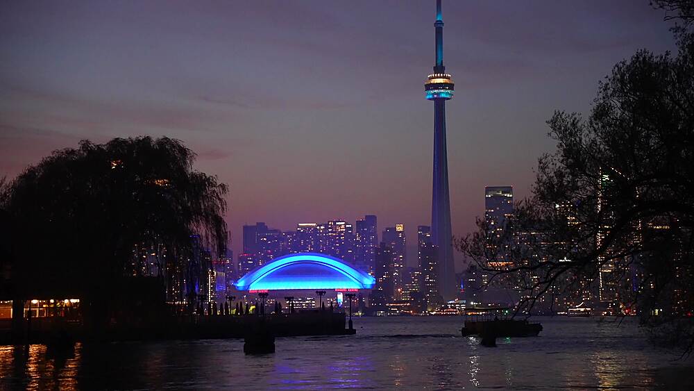 View of Toronto skyline and CN Tower from Middle Island at dusk, Toronto, Ontario, Canada, North America