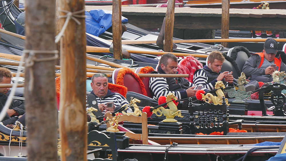 Gondoliers on their mobile phones, Venice, Veneto, Italy, Europe