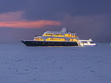 Dive boat anchored during sunset in the capital city of Mal in the Maldives highlighting evening activity in the sea