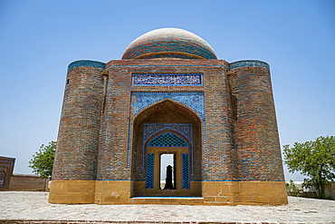 Visitors explore the historic architecture of the Makli Necropole site in Pakistan on a clear day