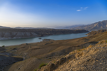 View from the overlook at Naghlu lake in eastern Afghanistan during daylight hours with mountains in the background