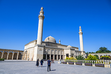 Visitors walk near the Jummah Mosque in Shamakhi while enjoying clear skies in Azerbaijan