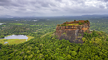 Aerial view of Sigiriya rock fortress in Sri Lanka surrounded by lush greenery and water bodies