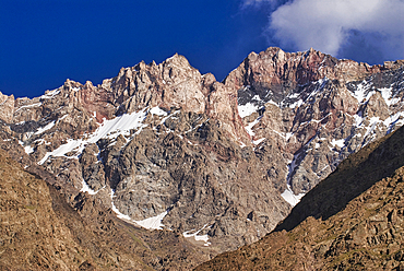 Dramatic mountain peaks rise in the arid landscape of Bartang Valley during a clear day in Tajikistan