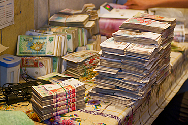 Kyrgyz som bills arranged on a table in Osh, showing currency exchange in a local setting