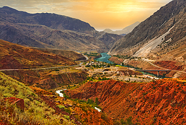 Mountain pass at sunset with river winding through valleys in Sary Chelek Kyrgyzstan