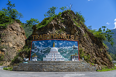 Bridge leads to Jamkhardrang Waterfall in Bhutan with clear blue sky and natural surroundings<br />1184-19192 Bridge leads to Jamkhardrang Waterfall in Bhutan with clear blue sky and natural surroundings