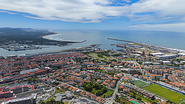 View from above of coastal city in Portugal showing residential areas, port, and sea