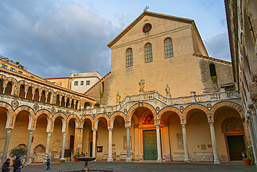 Salerno cathedral stands tall as visitors explore its courtyard in Campania, Italy, during the evening light<br />1231-427 Salerno cathedral stands tall as visitors explore its courtyard in Campania, Italy, during the evening light