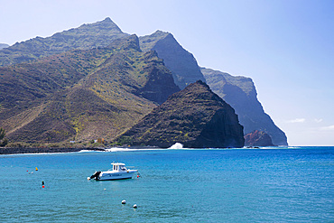 View across bay to the Caideros de Amurga, a range of jagged volcanic cliffs plunging into the Atlantic Ocean, Puerto de la Aldea, La Aldea de San Nicolas, Gran Canaria, Canary Islands, Spain