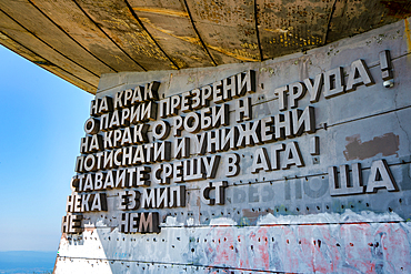 Cyrillic inscription at Buzludzha Monument showing Communist era message in Bulgaria's landscape