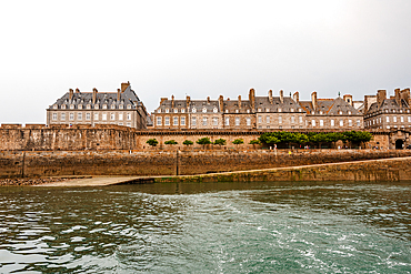 View of Saint Malo city walls and granite buildings from the sea in Brittany France
