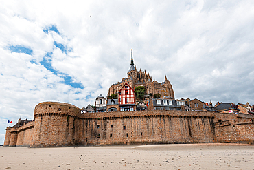 Historic stone ramparts and medieval houses stand tall in Mont Saint-Michel, showcasing architecture and history in Normandy, France