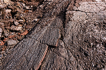 Folded and striated basalt lava surface close-up, flow lines and fractures in cooled pahoehoe lava, Fagradalsfjall 2021 eruption site, Geldingadalur, Reykjanes Peninsula, Iceland.