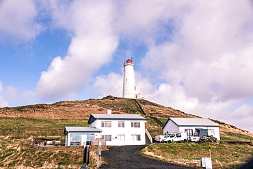 Reykjanesviti lighthouse and keeper's house on Baejarfell hill, Iceland's oldest lighthouse built 1878, white buildings on green and lava hillside, Reykjanesta, Reykjanes Peninsula, Iceland.