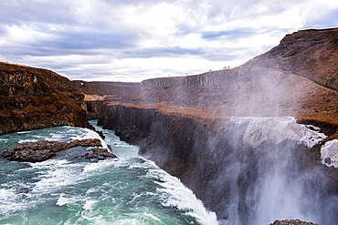 Gullfoss, Golden Circle, South Iceland. The mighty Gullfoss plunging into its rugged canyon with mist rising from the gorge. Iconic waterfall, raw power and dramatic unspoiled scenery on the glacial Hv&iacute;t&aacute; river.