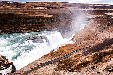 Gullfoss, Golden Circle, South Iceland. The mighty Gullfoss plunging into its rugged canyon with spray drifting from the gorge. Iconic waterfall, raw power and dramatic unspoiled scenery on the glacial Hv&iacute;t&aacute; river.