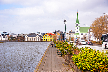 Fr&iacute;kirkjan &iacute; Reykjav&iacute;k, Reykjavik, Iceland. The white timber Free Church with its green spire on the shore of Tj&ouml;rnin pond, one of the city's most photographed landmarks. Iconic architecture and charming capital scenery.
