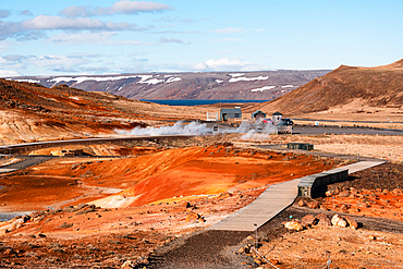 Selt&uacute;n geothermal area, Kr&yacute;suv&iacute;k, Reykjanes Peninsula, Iceland. Steaming vents and vivid orange sulphur-stained earth beside the lake, with geothermal pipework beyond. Volcanic landscape, geothermal energy and raw nature on the Mid-Atlantic Ridge.