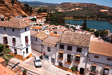 Izn&aacute;jar, C&oacute;rdoba, Andalusia, Spain. Terracotta rooftops of the whitewashed hilltop village above the turquoise Izn&aacute;jar reservoir. Pueblo blanco and dramatic Andalusian landscape.