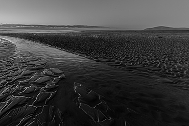 Ripples in sand lead to the Irish Sea near Black Combe on Walney Island along the Cumbrian Coast during low tide